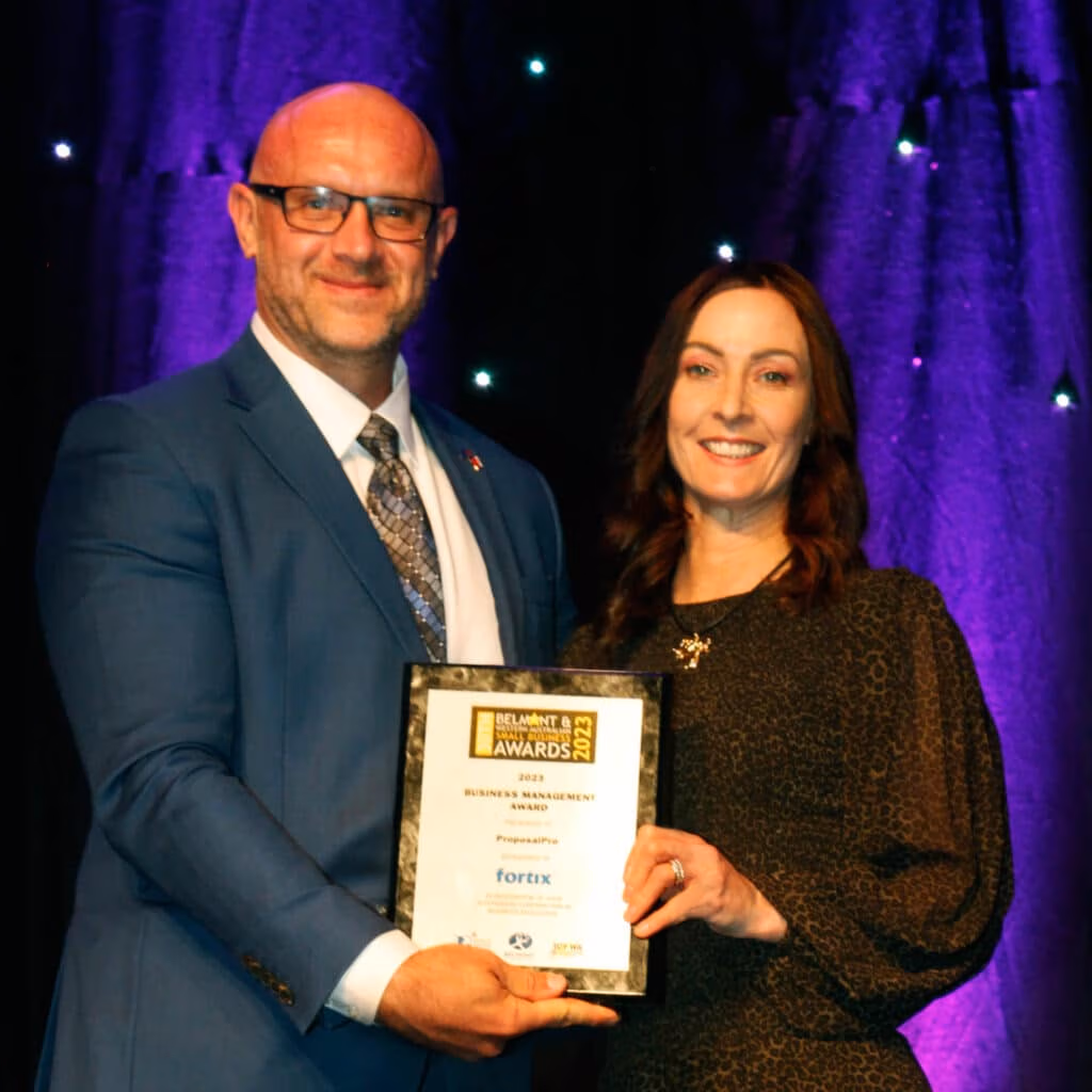 ProposalPro's principal consultant Roz Misiani accepting the Business Managemnent award from sponsor Paul Faix.